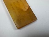 a piece of amber sitting on a white surface