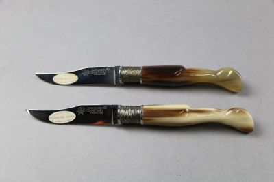 two knives that are sitting next to each other on a table