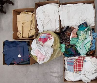 a box full of clothes that is sitting on the floor