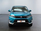 the front view of a blue suv parked in a room