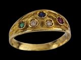 a close up of a gold ring with different colored stones