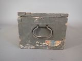 an old suitcase with a metal handle on a table