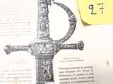 une photo d'un livre sur lequel figure l'image d'une épée