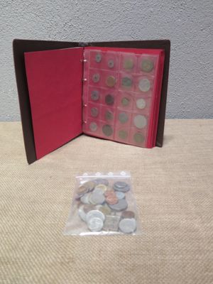 a small red book with buttons in it on a table