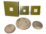 three coins and a small coin are sitting next to each other