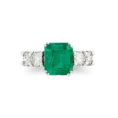 an emerald and diamond three stone ring