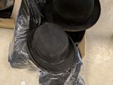 two hats that are sitting in a box on the floor