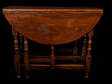 a small table with a wooden top on a black background