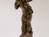 an antique bronze statue of a boy holding a bird on a marble base