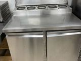 a stainless steel stove and a refrigerator in a kitchen