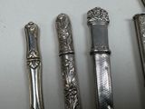 four spoons and a fork on a table