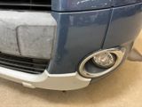 a close up of a car ' s front bumper and headlight