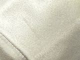 a close up picture of a white shirt with a button on it