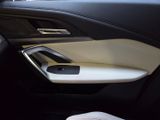 the interior of a car with the door open and a phone in the passenger seat