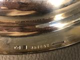 a close up of a silver plate on a leather surface