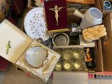 a box full of religious items sitting on the floor