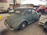 an old car that is sitting in a garage