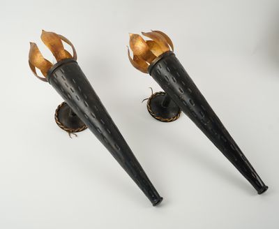 a pair of black and gold torches on a white surface