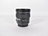 a black camera lens sitting on a white surface