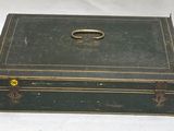 a green box with a gold ring on top of it