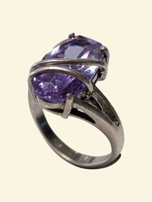 an image of a close up of a ring with a purple stone