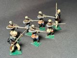 several figurines of men in uniforms with spears and shields
