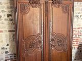 a large wooden armoire in the corner of a room