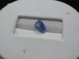 a blue stone in the middle of a white box