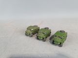 four toy army vehicles that are sitting on the ground