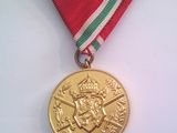 médaille ornée d'un ruban rouge, blanc et vert sur fond blanc