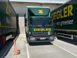 two semi trucks that are parked in a parking lot