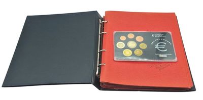 an image of a red binder with coins and a credit card in it