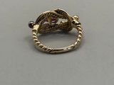 an image of a gold ring with a red stone in the middle