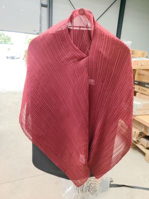 red shawl draped over a mannequin in a warehouse
