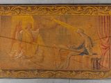 an old tapestry hanging on the wall of a building with a painting of a man and a woman