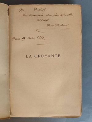 un livre ouvert avec une écriture dessus, posé sur une table