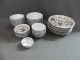 a lot of plates and bowls on the table