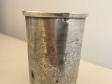 a silver cup that is sitting on a table