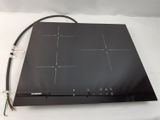 a close up of a black stove top on a white surface