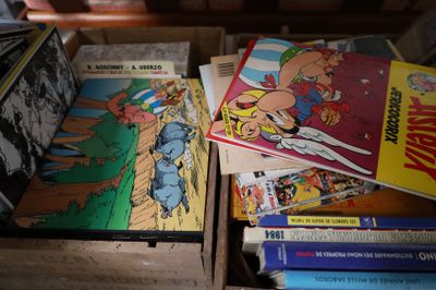 many comics in a wooden box on a table