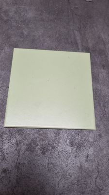 a piece of paper on the floor next to a pair of scissors