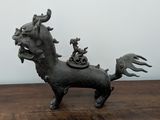 a small statue of a horse on a wooden table