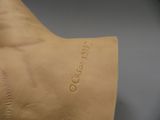 a close up of a sculpture of a person with a tattoo on their arm