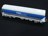 a white and blue train car sitting on a black surface