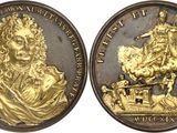 a close up of two gold coins with a man on a horse