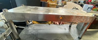 a metal table that is sitting in the middle of a room