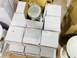 a pile of white boxes and a toilet in a room