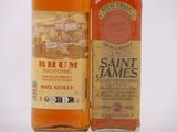 two bottles of rum sitting next to each other on a white surface