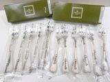 six silverware spoons in plastic bags on a white surface