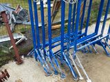 a lot of blue bike racks that are on the ground